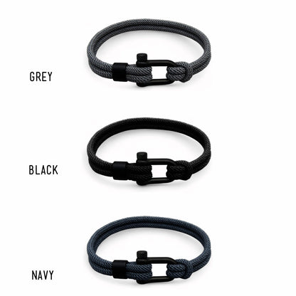 Three braided bracelets in grey, black, and navy with black clasp on a white background.